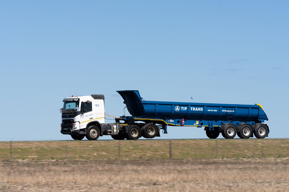 Truck pulling a back tipper trailer