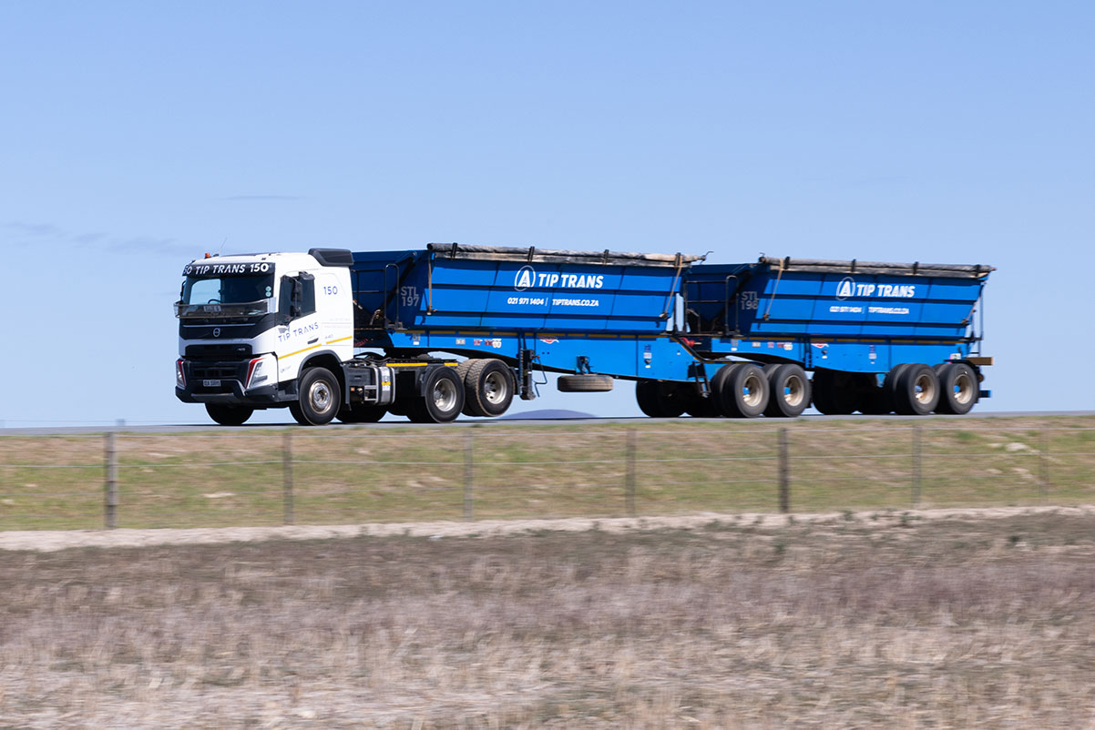 Truck pulling a side tipper trailer